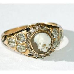 blackpaint20:  Golden Skull Ring, 18k gold with a carved agate skull surrounded by rose, diamonds and black enameling, with hallmarks for London 1852. There is an interior inscription on the ring: “James Dixon Obit 1852,” it memorializes James Dixon,