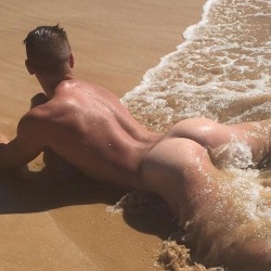 uncensoredpleasure:  It was a gay nude beach after all, with a cruising area nearby, but you were horrified when your husband’s latest twink stripped naked and laid down on the sand, right by the shore. He let the waves roll up on him, making his perfect