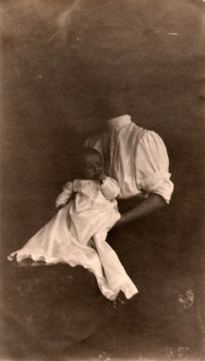 Headless mother holding her baby.