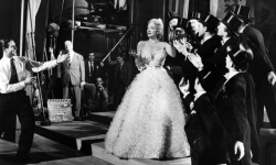 divadietrich:  Director Alfred Hitchcock watches as Marlene Dietrich (in Dior) rehearses a number from “Stage Fright”.   The laziest. 