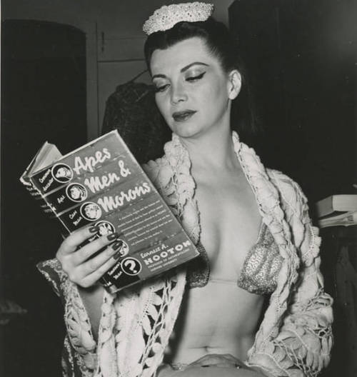 Apes, Men &amp; Morons (Stripper Reading a Book), c. 1950 ©  Weegee Nudes &amp; Noises  