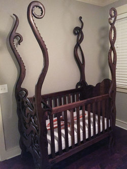 randomitemdrop: cultofweird:  Eldritch crib hand-carved by Garrick Andrus  Item: crib armed with tentacles to protect the baby in its care 