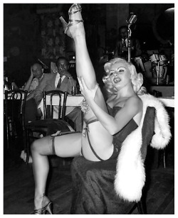 Rita Grable kicks up a shapely leg, during a performance at an unidentified 50’s-era nightclub..