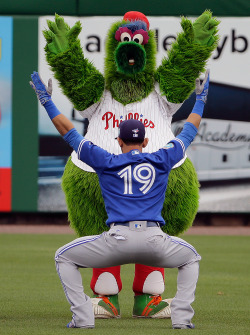 sportingnewsarchive:  PHOTO OF THE DAY: Philadelphia Phillies mascot the “Philly Phanatic” mocks Toronto Blue Jays’ Jose Bautista while he stretches in the outfield before a spring training baseball game Saturday, March 12, 2016, in Clearwater,