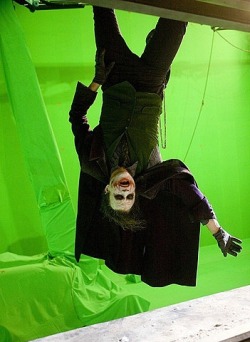 Just another lunatic hangin’ out (Heath Ledger is suspended in front of a “green screen” while filming “The Dark Knight”)