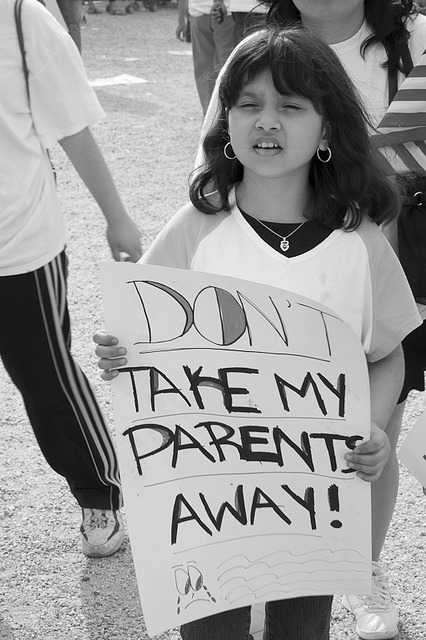Photo of a little girl holding a sign that reads 