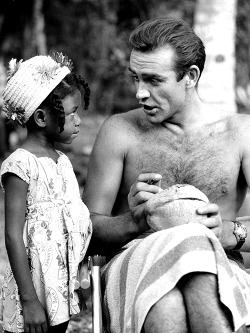  Sean Connery signing a coconut for a little Jamaican fan on the set of Dr. No, 1962 