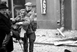 bag-of-dirt:  A wounded Finnish man is carried to safety following a Soviet bombing raid in Helsinki during the Finnish-Soviet Winter War. Helsinki was bombed a total of eight times during the Winter War. Some 350 bombs fell on the city, resulting in