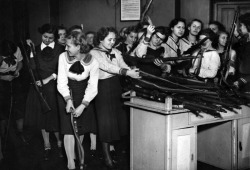 Military training has been introduced to the schools in Budapest. Here the pupils of a girl&rsquo;s school are issued with their arms, 1939.