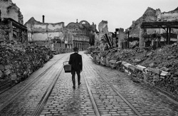 A man walks through the destroyed city looking for food, 1945. &copy; Werner Bischof