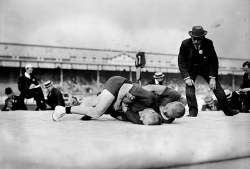 wrestlingroots:  Wrestling during the 1908 Olympics - A referee closely watches the final of the light heavyweight Greco-Roman wrestling event. Verner Weckman of Finland won the gold medal, beating fellow countryman Yrjo Saarela. 