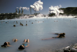 Swimmers in a therapeutic thermal lake created from a power plant, Blue Lagoon, Iceland by Richard Nowitz.