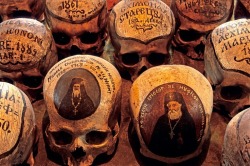Dated skulls, Romania - The skulls in the ossuary of the 15th century Neamt Monastery bear little texts stating the names and dates of the monks. Photo Mick Palarczyk.