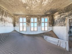 creativehouses:Sand has overtaken a room in abandoned diamond-mining town of Pomona on the Namibian coast. via reddit