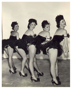 Vintage 50’s-era photograph features a quartet of showgirls posing Backstage, at an unidentified nightclub or theatre..