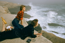  Two women gaze at heavy surf while lying on boulders on the coast of Nova Scotia, December 1961. Photograph by Volkmar Wentzel, National Geographic 