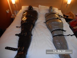 heavy-bondage:  Strapped up and mummified for the first time courtesy of Tie ‘Em Up. I’m the black mummy…no idea who the other fella is! http://www.xtube.com/video-watch/Wrapped-in-Duct-Tape-and-Encased-in-Rubber-28984771 