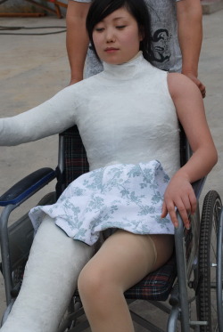 Female patient in body cast, legcast, armcast and wheelchair (Cast fetish)