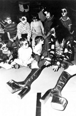 Gene Simmons with miniature Kiss fans, 1970s.