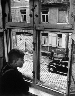 Boy looking out of window, Ansbach, Germany photo by Carl Mydans, 1954