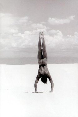 Naked handstand on the beach.