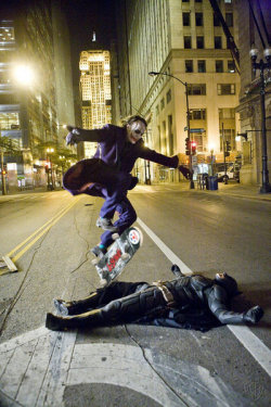 fluorideuraniumcarbonpotassium:Heath Ledger as the Joker skate boarding over Christian Bale as Batman while they take a break on the set of The Dark Knight.