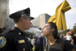 stonerparty: APTOPIX Mexico Massacre Anniversary A  protester blows marijuana smoke in the face of a police officer during a  march to mark the 1968 Tlatelolco plaza massacre in Mexico City 