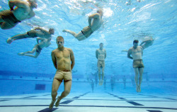 newsweek:  cheatsheet:  Navy SEAL trainees bounce off the bottom of the tank to catch their breath during the Drown Proofing Test at the Combat Training Tank. The trainees have their feet and hands tied and once freed they swim to safety.  The SEALs: