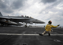 youlikeairplanestoo:  ARABIAN SEA (Jan. 23, 2011) Lt. Cmdr. Jessica Parker, from St. Louis, launches an F/A-18F Super Hornet assigned to the Bounty Hunters of Strike Fighter Squadron (VFA) 2 aboard the aircraft carrier USS Abraham Lincoln (CVN 72). Female