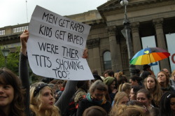 loverwife:  [image description: photograph of a crowd at a rally; one individual is holding a hand-written sign above her head; text of sign reads “MEN GET RAPED. KIDS GET RAPED. WERE [THEIR] TITS SHOWING TOO?”; end description] 