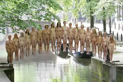 specialnudes:  In 2007 Spencer Tunick was commissioned to make this piece of art. A special bridge construction was made to create the illusion that the people were floating over the water. 