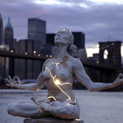 official310:   Paige Bradley created one of the most striking sculptures I’ve seen in recent times. Her masterpiece, entitled Expansion, is a beautiful woman seeking inner piece but fractured and bleeding with light. “From the moment we are born,