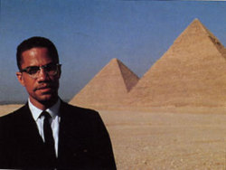  Malcom X standing just outside of The Great Pyramids of Giza, in Egypt. 