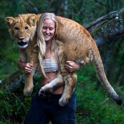 stfurodrigo:   Tamblyn Williams carries six-month-old lion cub Jagger on her shoulders. Jagger arrived at Seaview Lion Park in Port Elizabeth, South Africa, from a different lion park where he was part of a breeding programme. But he was abandoned just