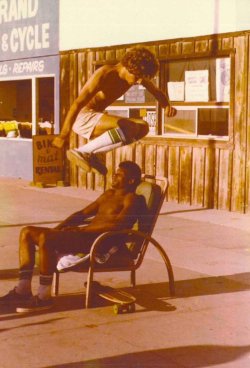 lonesomelacowboy:  A skateboarder named Mike Kolar jumping a local man named Cosmo - Hermosa Beach - circa 1975 