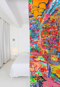  Sleep in a Work of Art Graffiti artist Tilt finished this piece (called The Panic Room) for the Au Vieux Panier hotel in Marseille, France. And yes, the room is completed - split down the middle the stark whiteness really plays up the mass graffiti