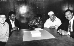 Flava Flav sits with Lyor Cohen, his lawyers, and Russell Simmons as he signs a solo deal with RUSH productions. (1988)