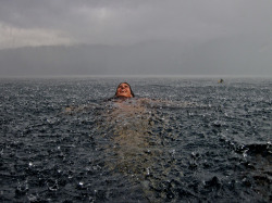 Swimming nude in the rain.