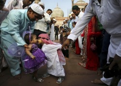 danceswithfaeriesunderthemooon:  haleyfood:  An Indian Muslim boy leans to rub noses with a girl as they are both dressed up for Eid al-Fitr (the end of Ramadan) prayers at the Jama Masjid in New Delhi, India, Aug. 20, 2012. Photography by: Kevin Frayer