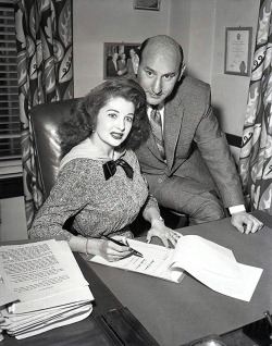 Tempest signs a Million Dollar contract! A vintage press photo from late &lsquo;56, shows Tempest Storm (with Frank Engel) signing a 10-year contract with the 'Bryan-Engel Burlesque Theatres&rsquo; chain, worth a sum total of 1 million dollars.. She agree