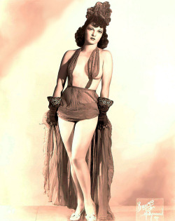 Ann Corio   aka. “Her Majesty the Queen”.. Born of Italian heritage, she was raised in Hartford, Connecticut.. At the age of 15,  she travelled to Depression-era New York City looking for work as a showgirl.. By 1929, she would be headlining the