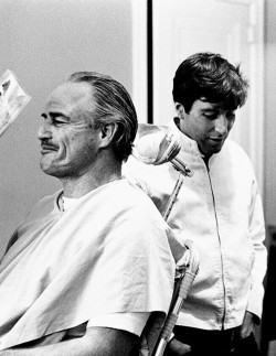 Marlon Brando chuckles as Al Pacino cracks a joke on the set of “The Godfather” (1972)